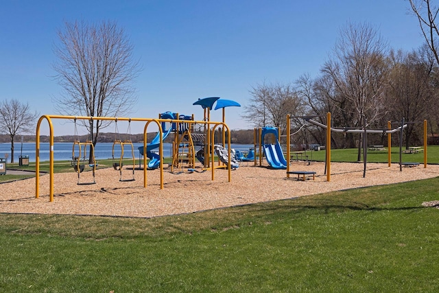 view of jungle gym featuring a lawn and a water view