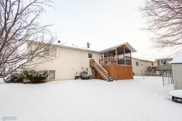 1215 18th St N, Moorhead, MN 56560 - snow covered back of property with stairway and a sunroom