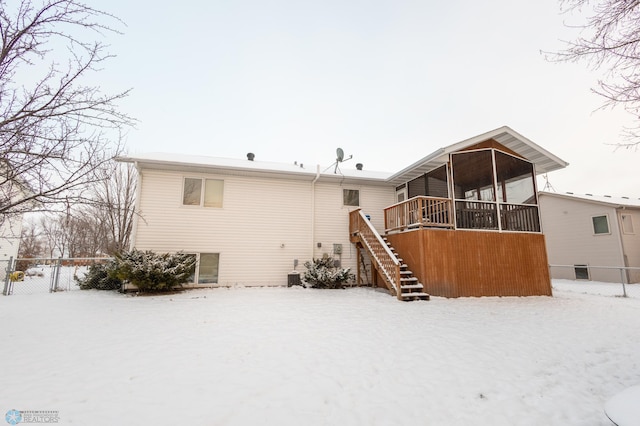 1215 18th St N, Moorhead, MN 56560 - snow covered property featuring a sunroom and stairs