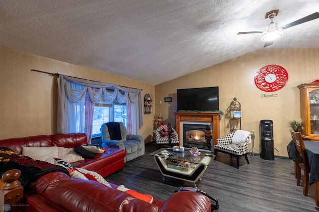 1215 18th St N, Moorhead, MN 56560 - living area with lofted ceiling, ceiling fan, wood finished floors, a glass covered fireplace, and a textured ceiling