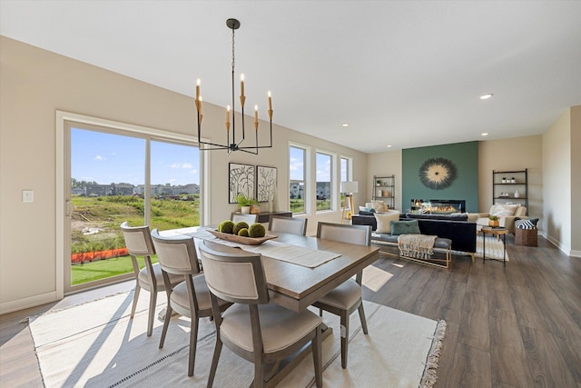 dining area with hardwood / wood-style flooring and a notable chandelier