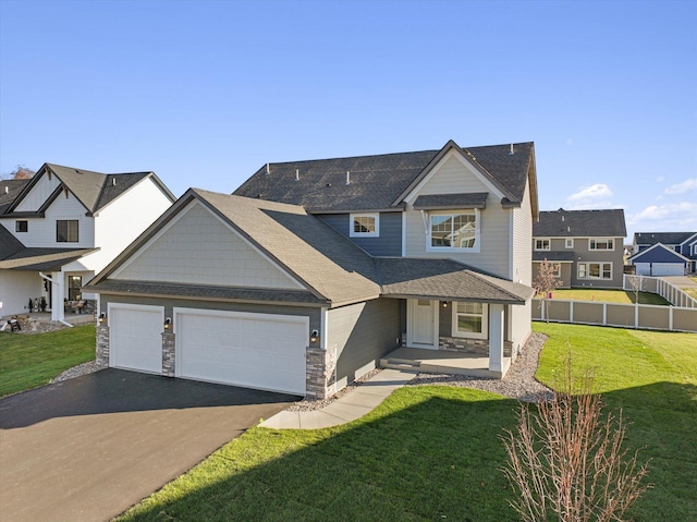 craftsman-style house featuring a garage and a front lawn