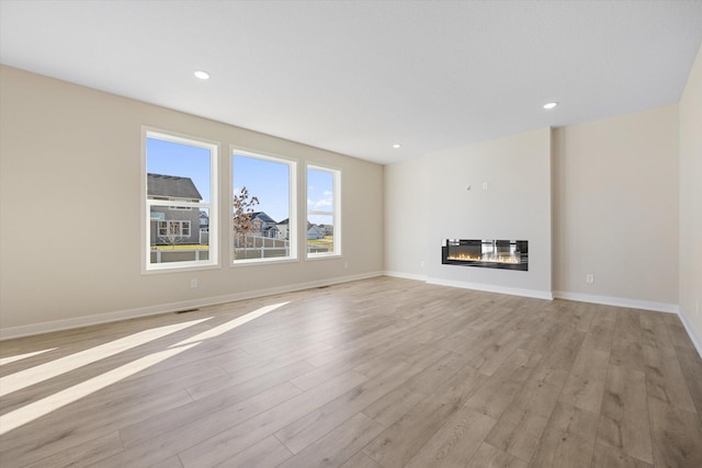 unfurnished living room featuring light wood-type flooring