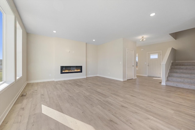 unfurnished living room with light wood-type flooring