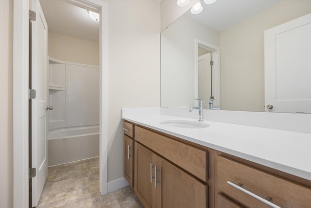 bathroom featuring a textured ceiling and vanity