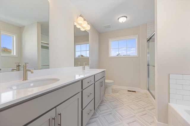 full bathroom featuring a wealth of natural light, vanity, and independent shower and bath