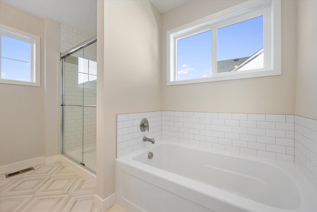 bathroom with tile patterned floors and separate shower and tub