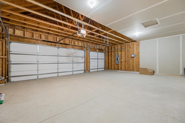 garage featuring electric panel and a garage door opener