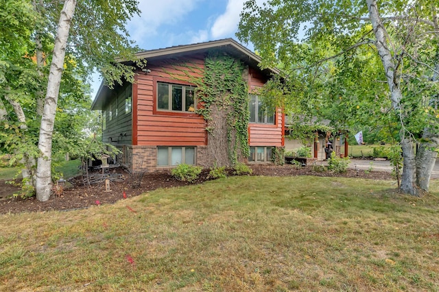 view of side of home featuring a yard