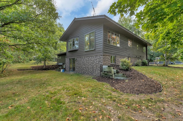 view of side of property featuring a yard