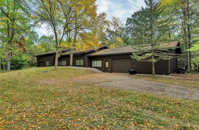 view of property exterior featuring a lawn and a garage