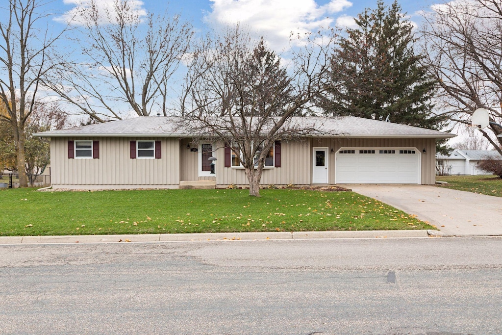 view of front of home featuring a garage and a front lawn