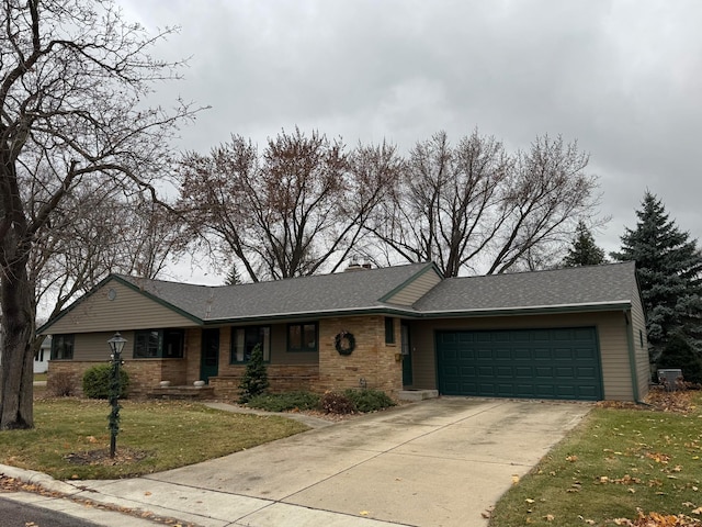 view of front facade with a front yard and a garage