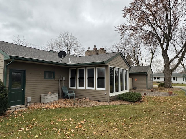 back of property featuring a lawn and a sunroom