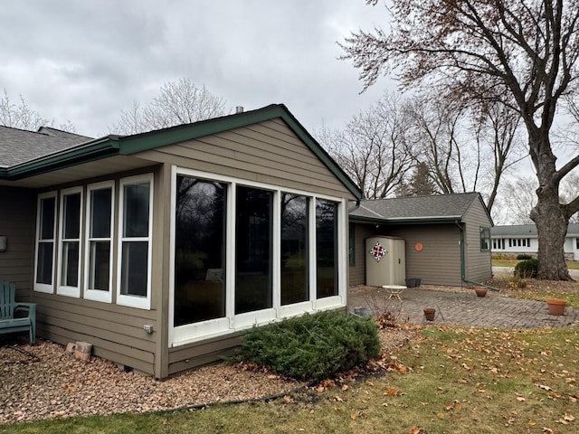 view of home's exterior featuring a patio area and a sunroom