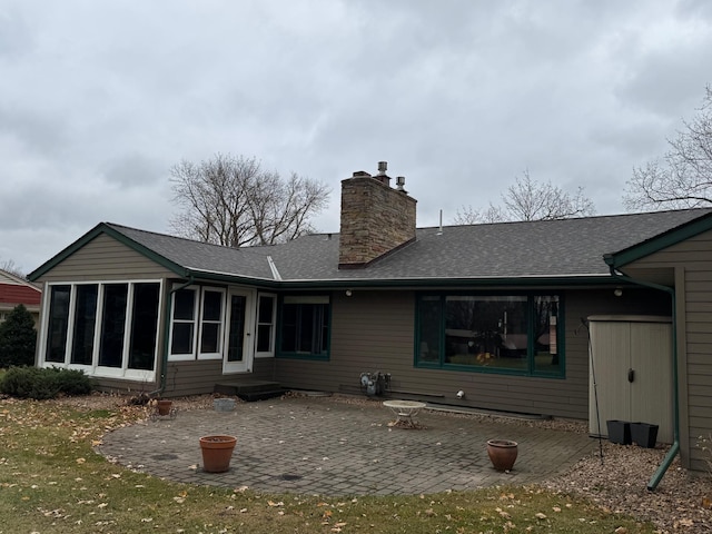 back of house featuring a sunroom and a patio