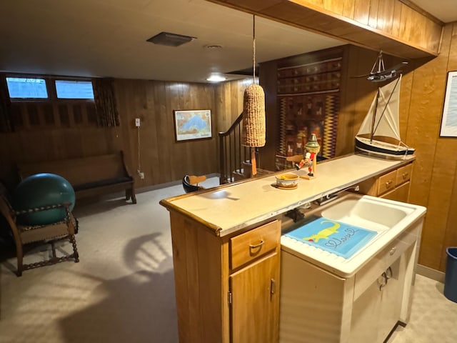 bar featuring wood walls, light carpet, and decorative light fixtures