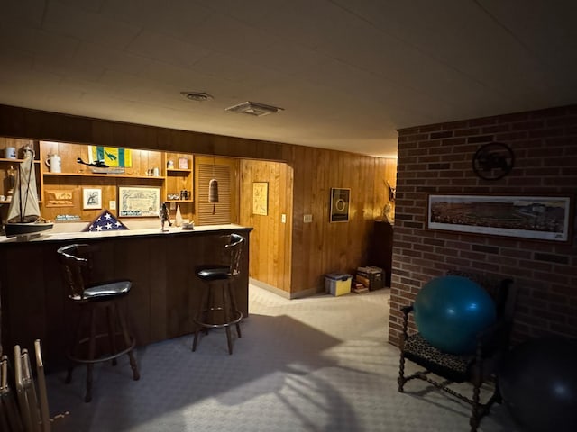 bar with light colored carpet and wood walls