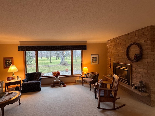 living area with carpet flooring, a textured ceiling, and a stone fireplace