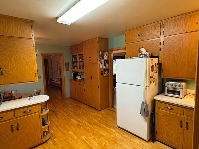 kitchen with white fridge and light hardwood / wood-style flooring