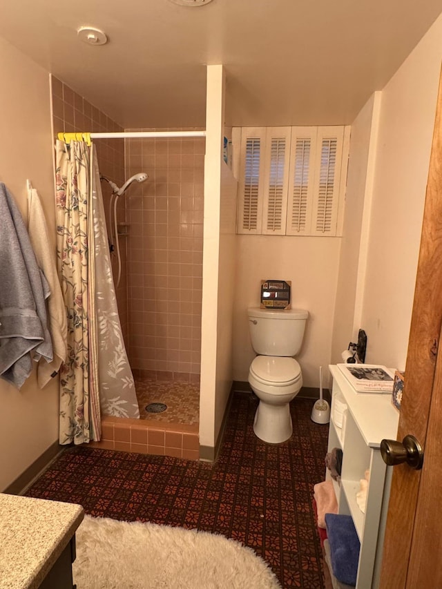 bathroom with tile patterned floors, toilet, vanity, and a shower with shower curtain