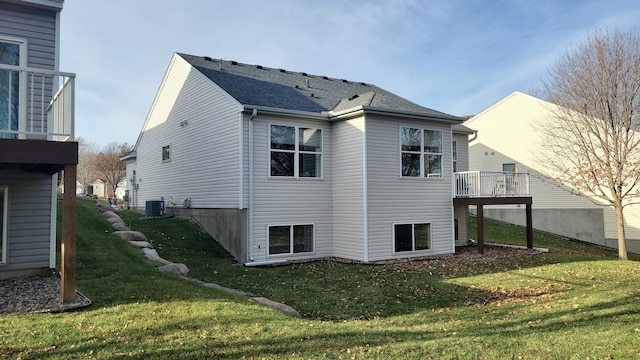 back of property featuring cooling unit and a yard