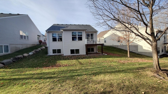 back of house with a wooden deck and a yard