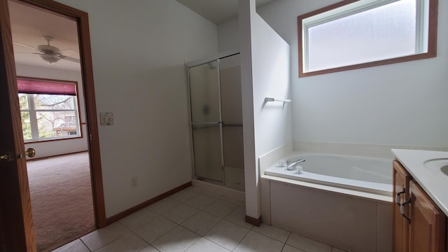 full bathroom featuring tile patterned flooring, ceiling fan, a stall shower, a bath, and vanity