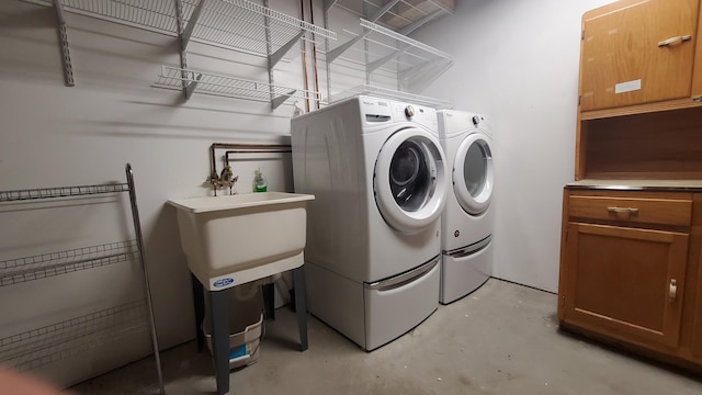 washroom with washing machine and clothes dryer and cabinet space