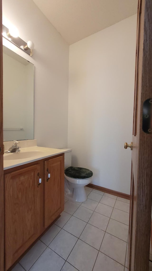 bathroom with vanity, tile patterned floors, toilet, and baseboards