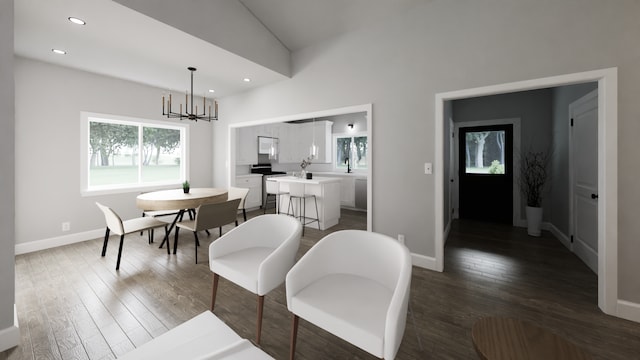 dining space with vaulted ceiling, dark hardwood / wood-style flooring, and a chandelier