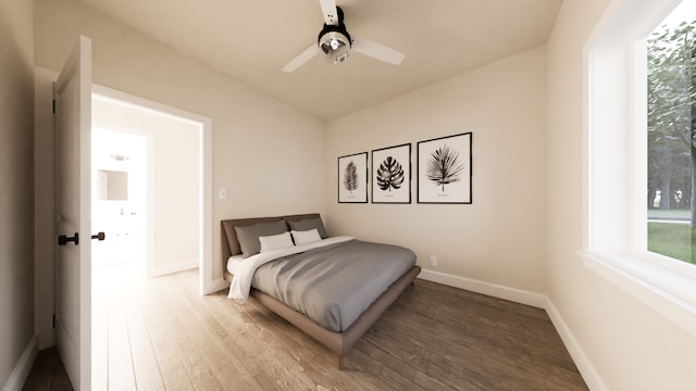 bedroom featuring ceiling fan, wood-type flooring, and vaulted ceiling