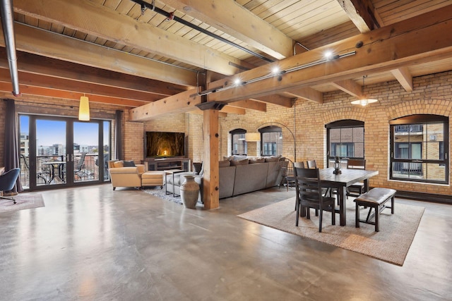 dining space with beam ceiling, wooden ceiling, brick wall, concrete flooring, and a fireplace