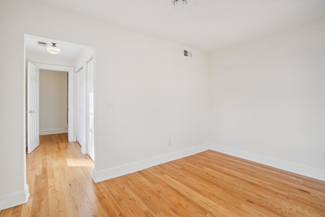 empty room with hardwood / wood-style flooring