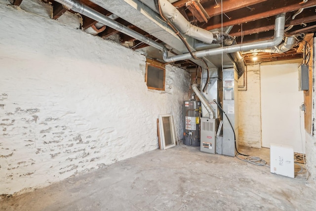 basement with gas water heater, electric panel, and heating unit