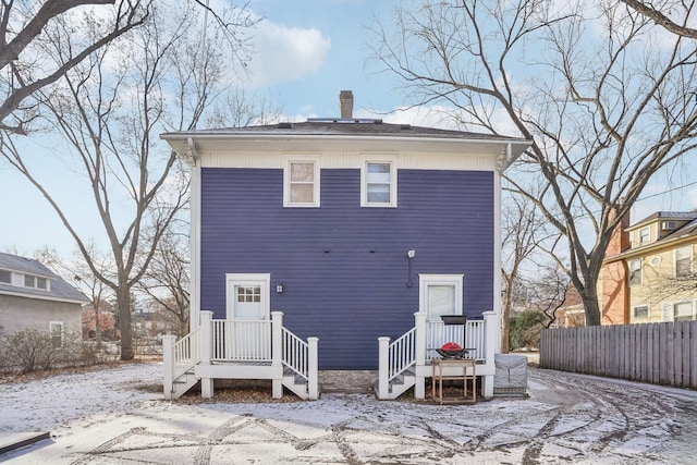 view of snow covered rear of property