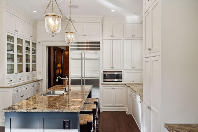 kitchen with glass insert cabinets, white cabinetry, stainless steel appliances, and a sink