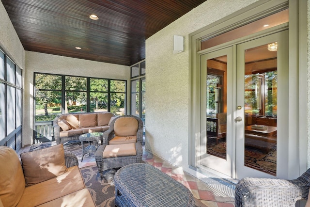 sunroom / solarium featuring wood ceiling and french doors