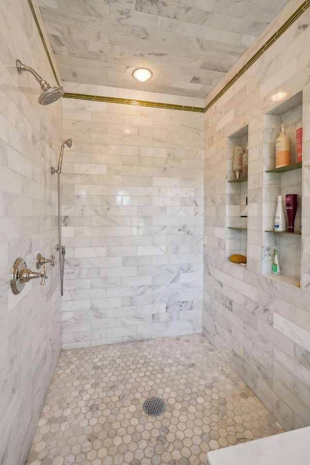 bathroom with a tile shower