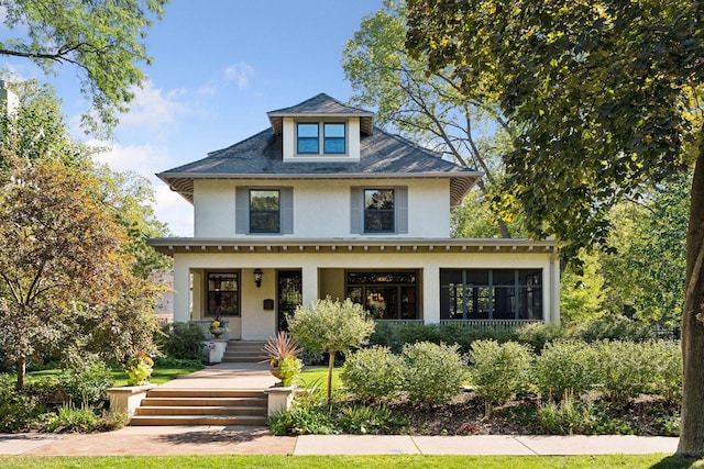 traditional style home with a porch and stucco siding