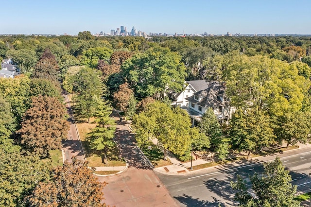 drone / aerial view with a city view and a wooded view