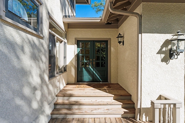 property entrance featuring french doors and stucco siding