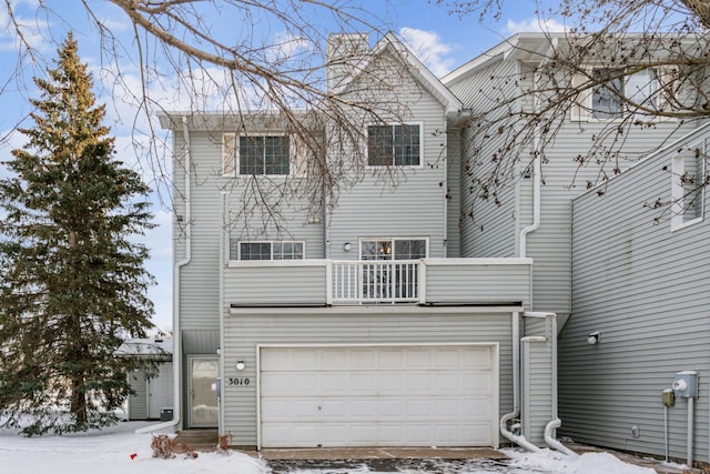 view of front of home with a balcony and a garage