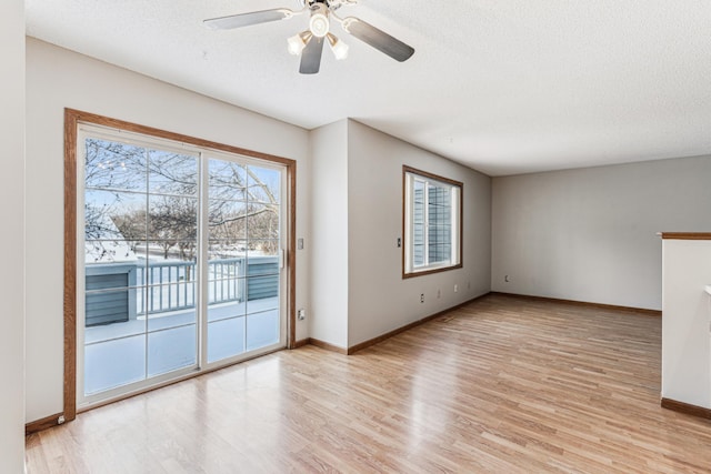 unfurnished living room featuring light wood-type flooring, ceiling fan, and a textured ceiling