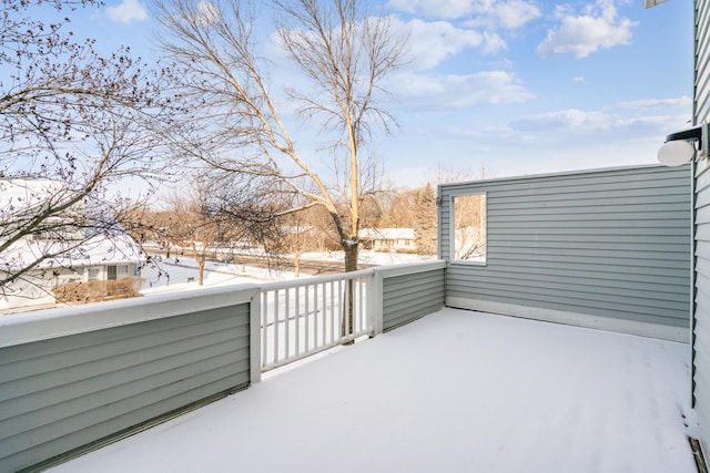 snow covered patio with a balcony