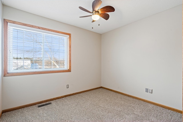 unfurnished room with ceiling fan and carpet flooring