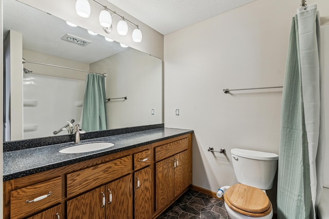 bathroom featuring toilet, vanity, a textured ceiling, and curtained shower