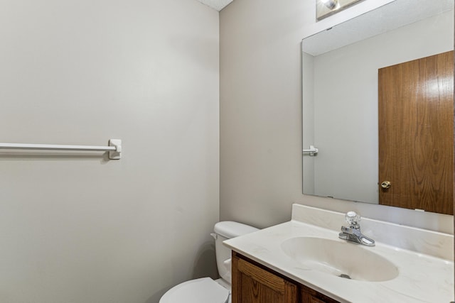 bathroom with toilet and vanity