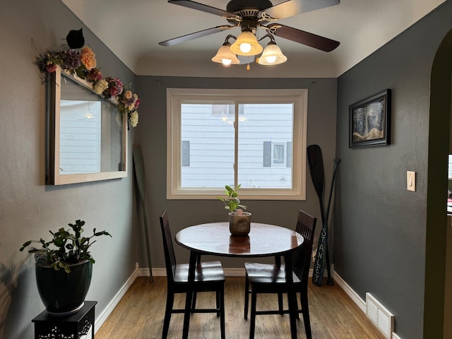 1630 3rd St N, Fargo, ND 58102 - dining area featuring a ceiling fan, light wood-style floors, and arched walkways