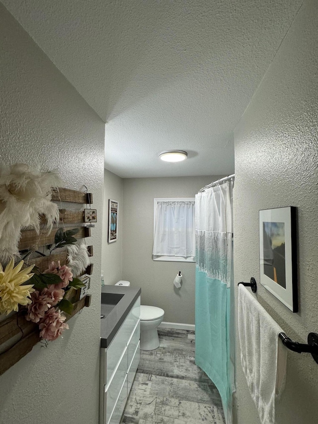 1630 3rd St N, Fargo, ND 58102 - full bathroom with wood finished floors, a textured ceiling, vanity, a textured wall, and curtained shower